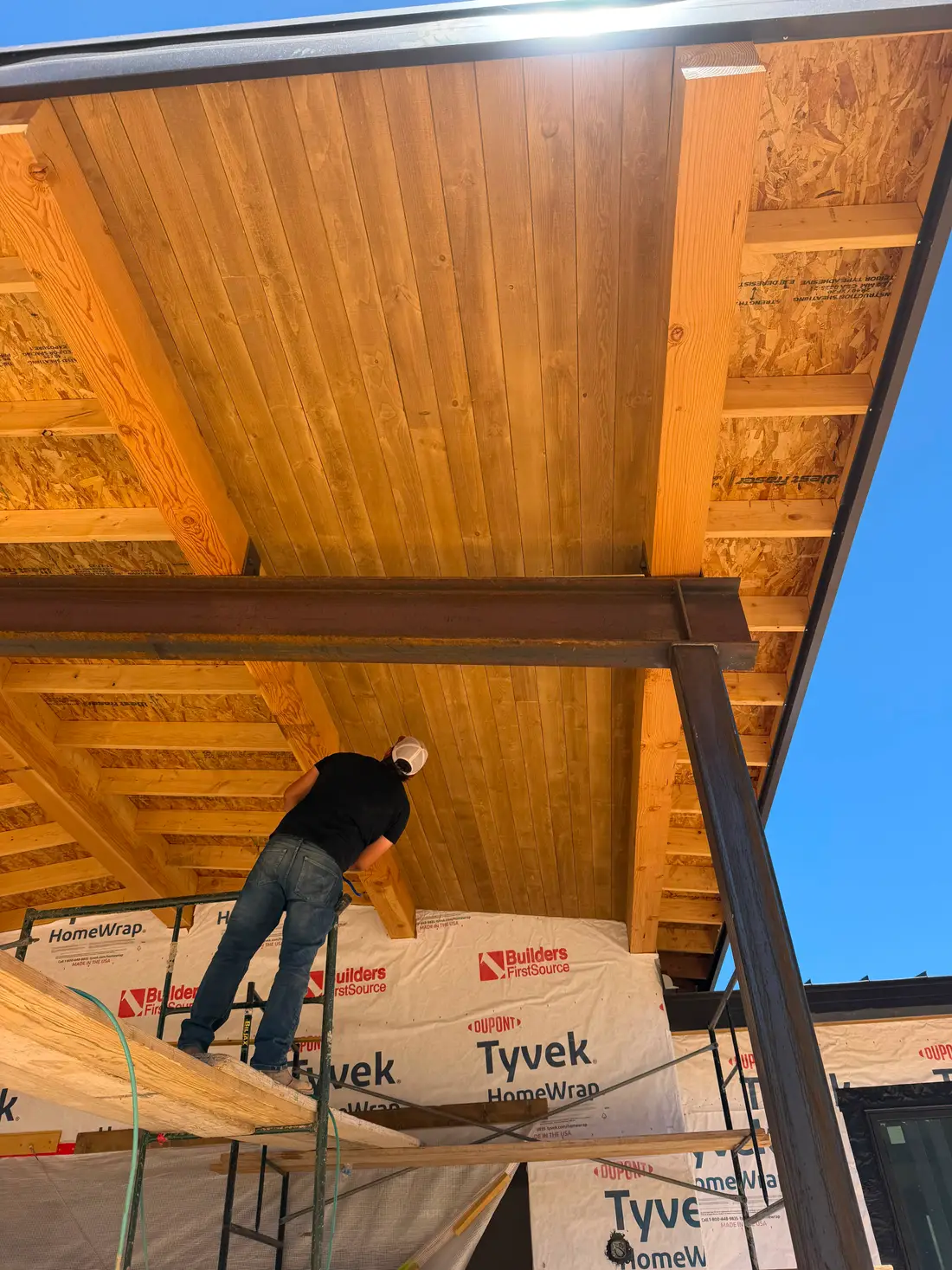 JH Construction crew member installing exterior wood soffit in Farmington, NM