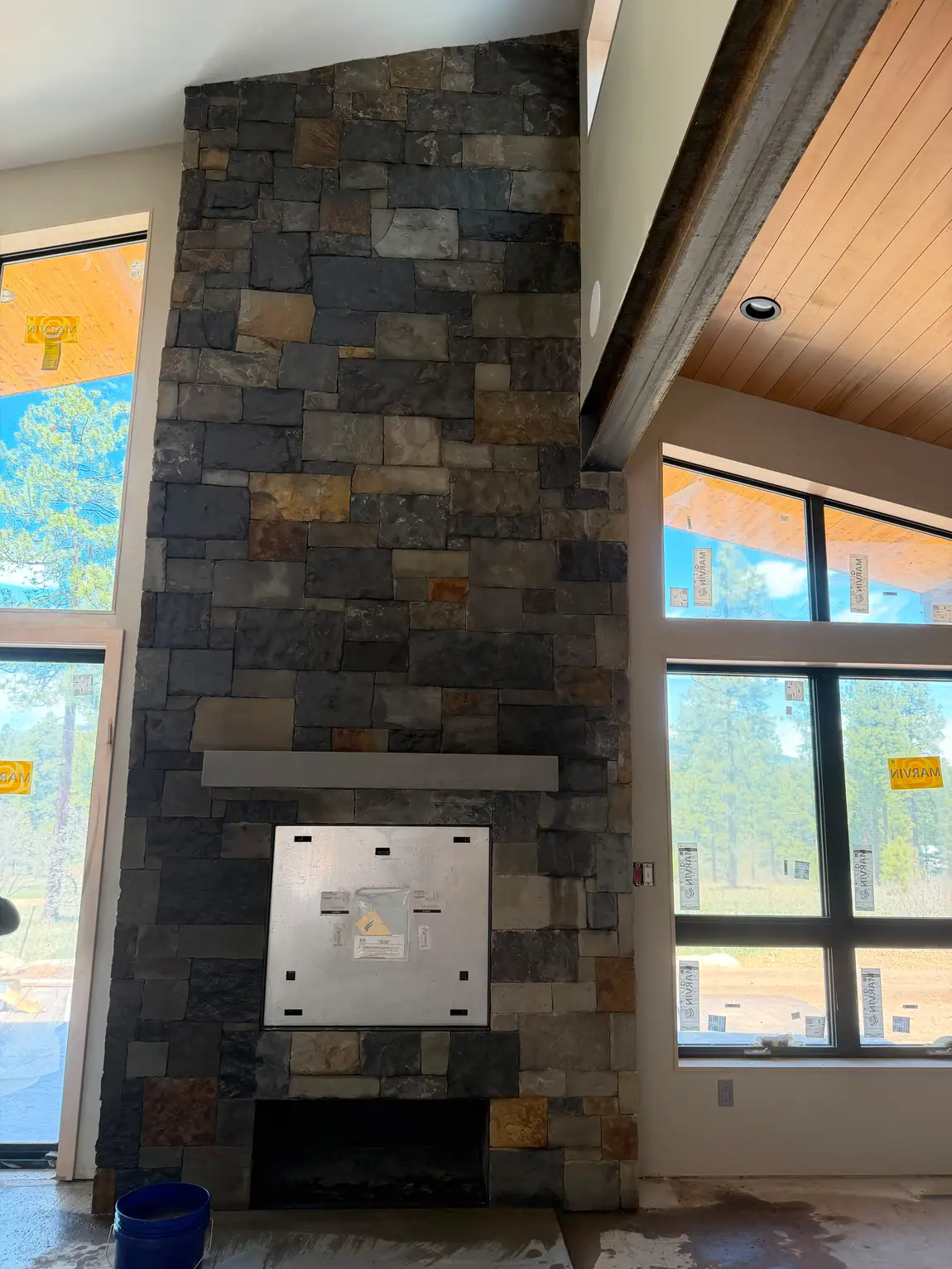 Floor-to-ceiling stone fireplace built by JH Construction, San Juan County, NM