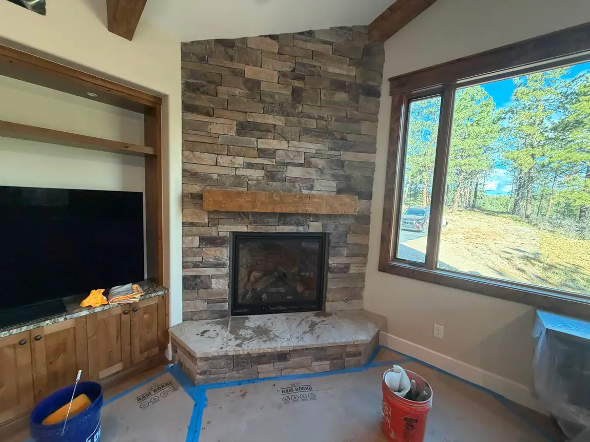 Stone fireplace with large view window built by JH Construction, San Juan County, NM