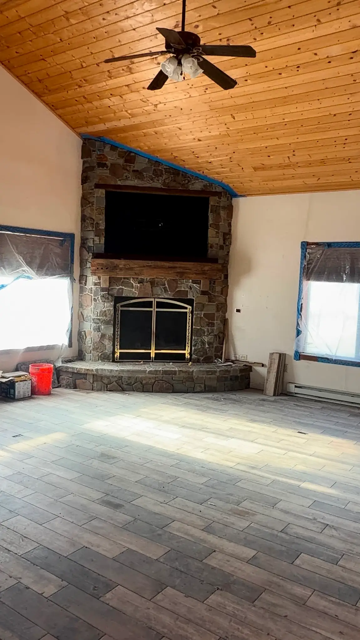Stone fireplace with vaulted wood ceiling built by JH Construction, San Juan County, NM