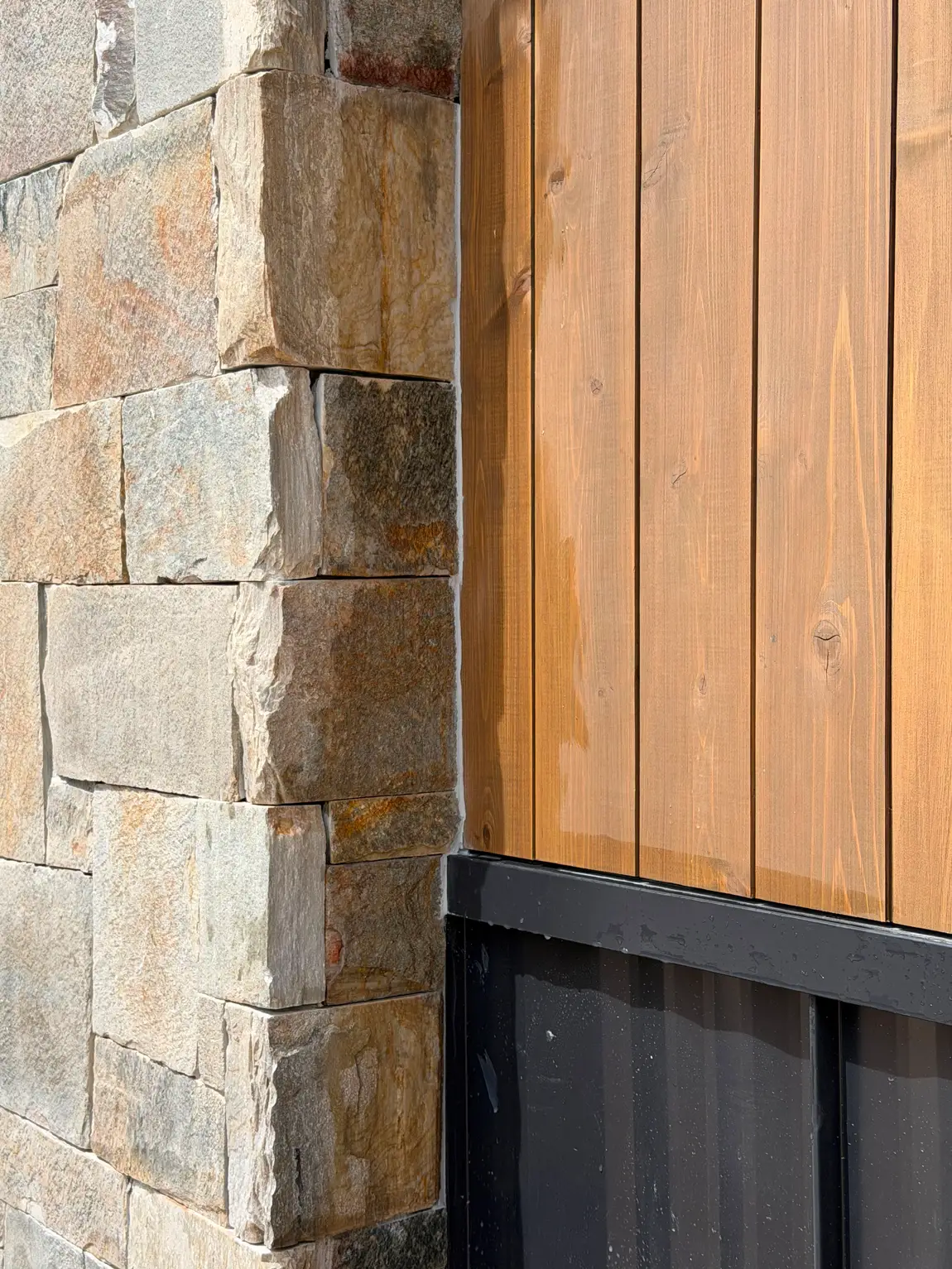 Stone corner detail with wood siding by JH Construction, San Juan County, NM
