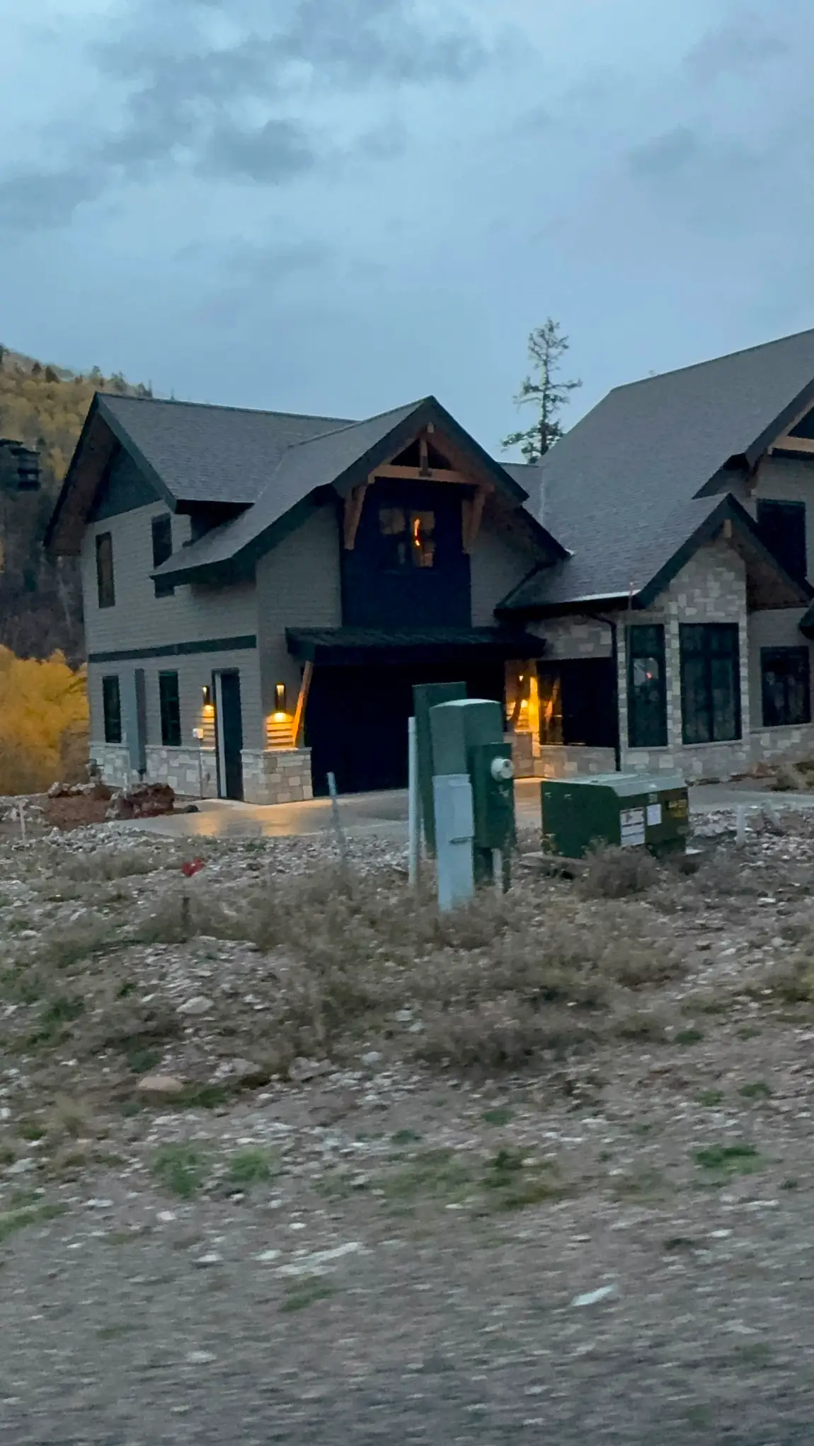 Twilight view of a stone-accented home exterior built by JH Construction, San Juan County, NM