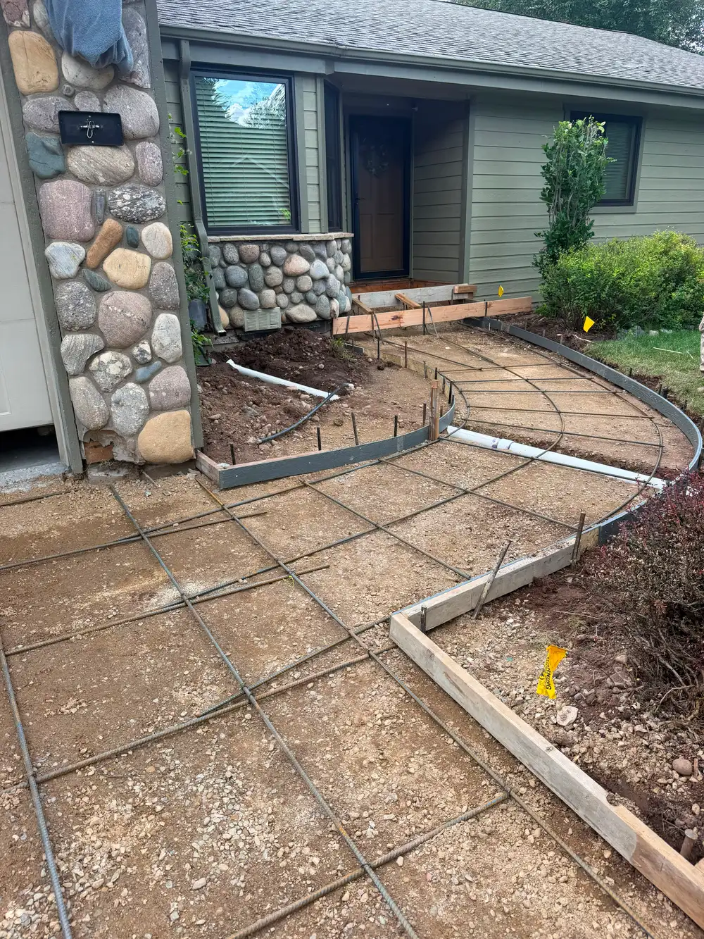 House exterior with river-rock stone columns built by JH Construction, San Juan County, NM